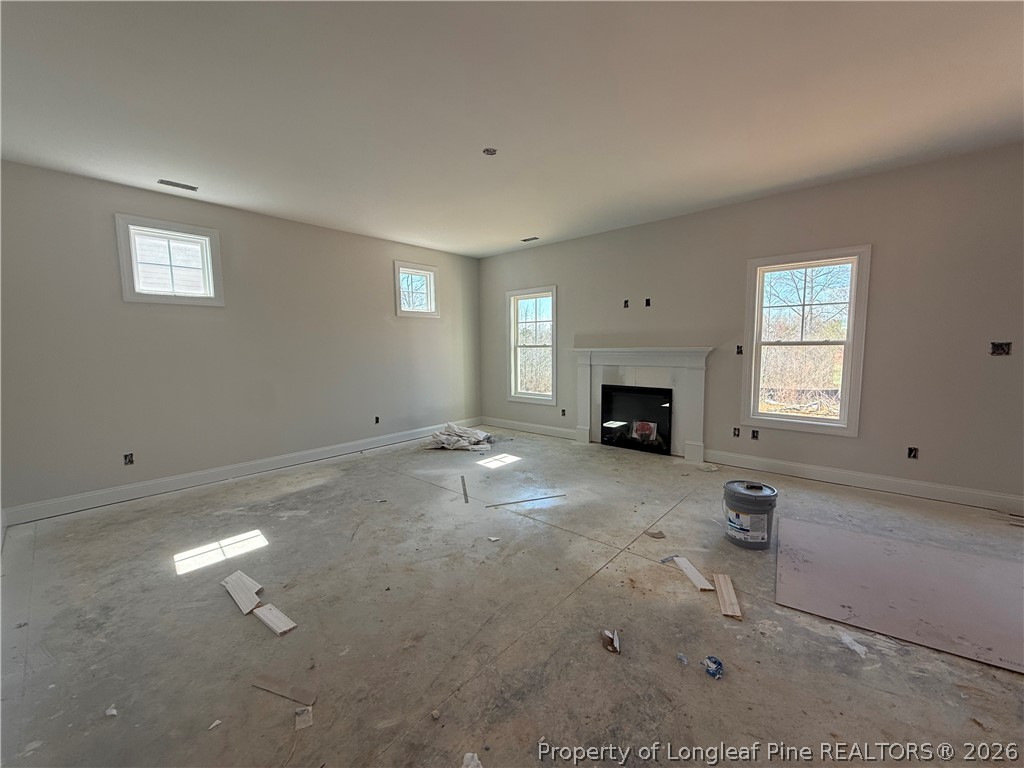 178 Brickendon Lane Raeford, NC 28376 - Photo 2 of 15 an empty room with fireplace and window