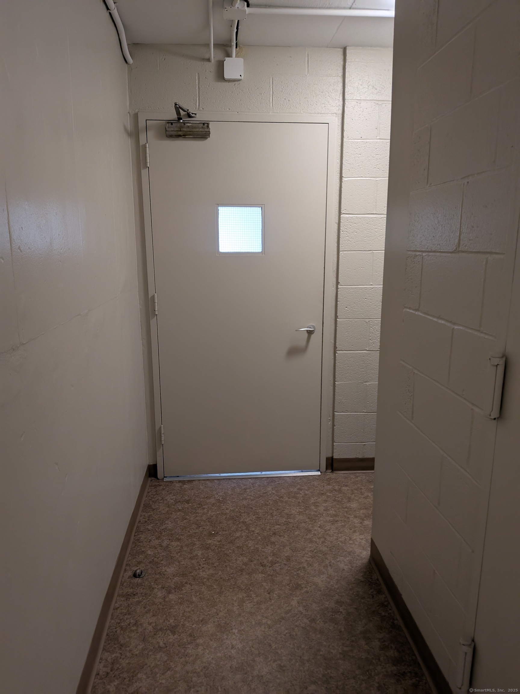 1 Gold Street, Unit 16F Hartford, CT 06103 - Photo 15 of 20 an empty room with a wooden door