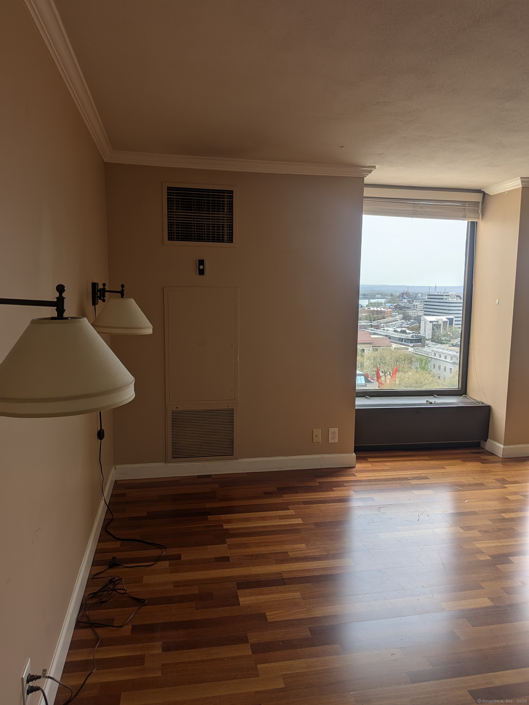 1 Gold Street, Unit 16F Hartford, CT 06103 - Photo 4 of 20 a view of a room with wooden floor and window