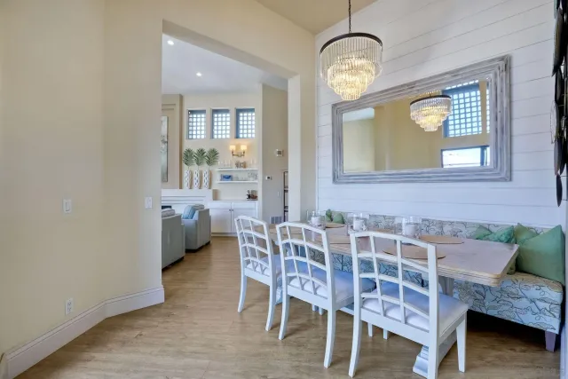 a view of a dining room with furniture and a chandelier