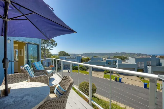 a view of a balcony with furniture