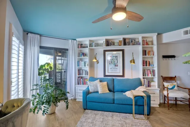 a living room with furniture cabinets and window