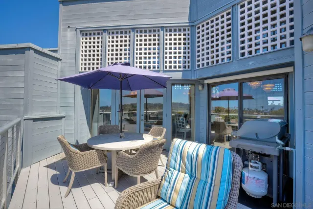 a view of balcony with seating space and wooden floor