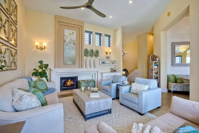 a living room with furniture fireplace and a large window