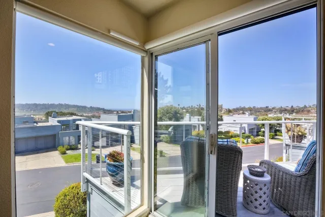 a living room with furniture and a view of kitchen