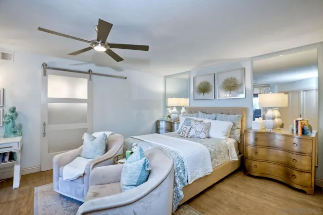 a bedroom with a bed and a chandelier