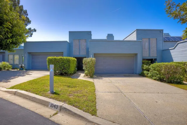 a bathroom with a bathtub shower sink vanity mirror and toilet