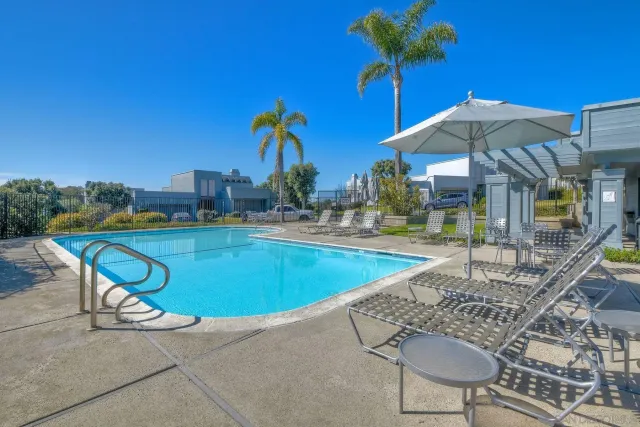 a view of house with a swimming pool