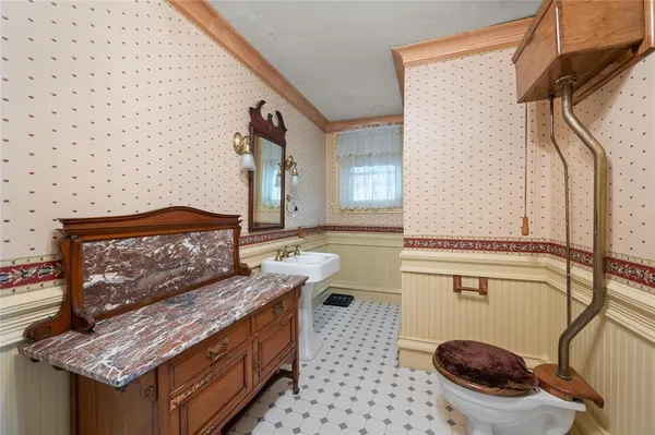 a bathroom with a granite countertop sink a toilet and a mirror