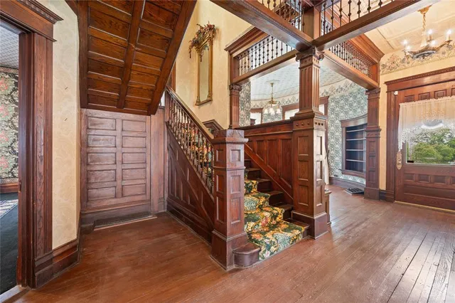 a view of a livingroom with wooden floor and a fireplace