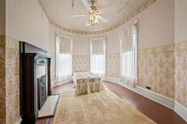 a spacious bedroom with a large bed and a chandelier