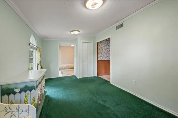 an empty room with wooden floor chandelier fan and windows