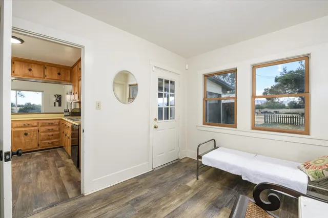 a view of a bedroom with wooden floor and a window