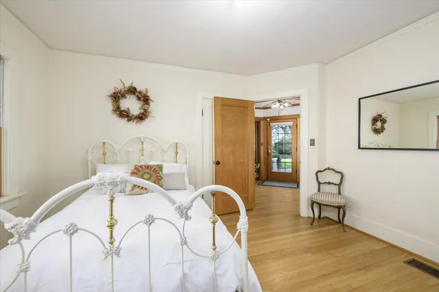 a view of a bedroom with furniture and wooden floor
