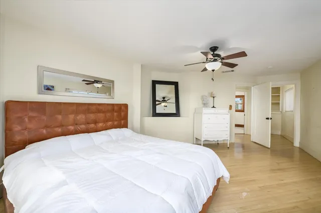 a bedroom with a large bed and a chandelier