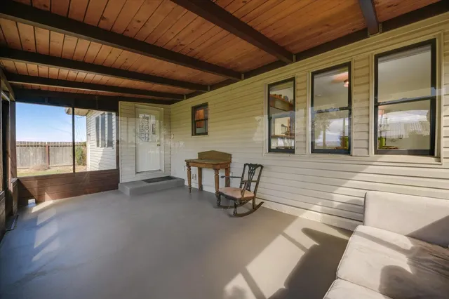 a view of a livingroom with furniture and windows