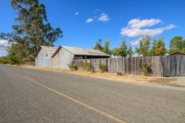 a backyard of a house with table and chairs