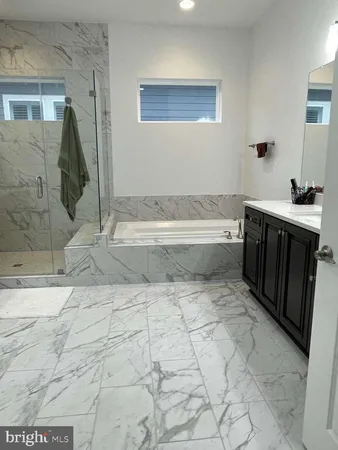 a spacious bathroom with a tub and sink