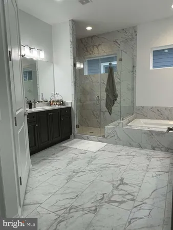 a bathroom with shower sink and mirror