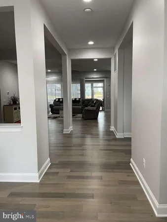 a view of living room with furniture and wooden floor