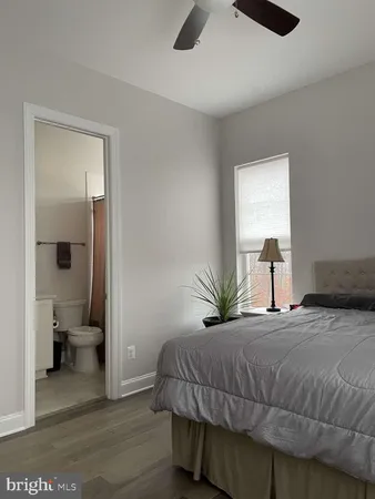 a bedroom with a bed and painting on the wall