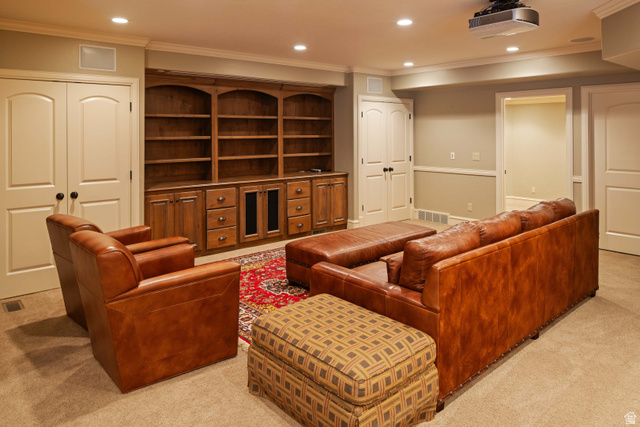875 South 1250th Street East Mapleton, UT 84664 - Photo 46 of 54 Spacious entertainment room featuring recessed lighting, crown molding, and a built-in wood-finish media center with shelving and storage