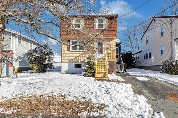 a view of a house with snow on the road