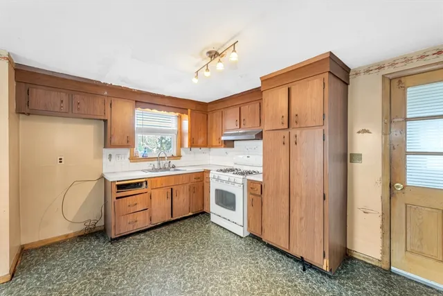 a kitchen with white cabinets and white appliances