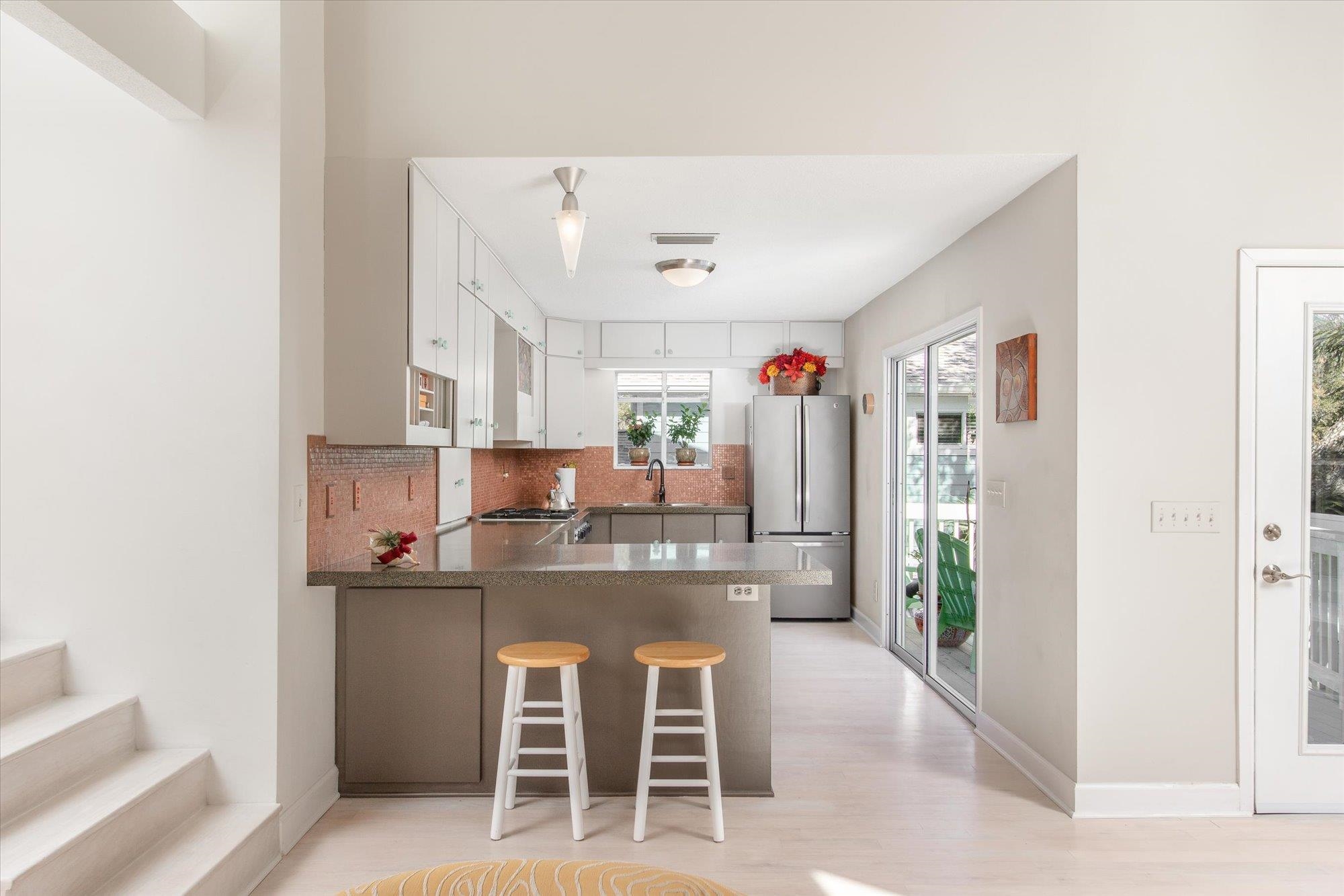 1685 Santander Street St. Augustine, FL 32080 - Photo 14 of 48 a kitchen with kitchen island cabinets and refrigerator
