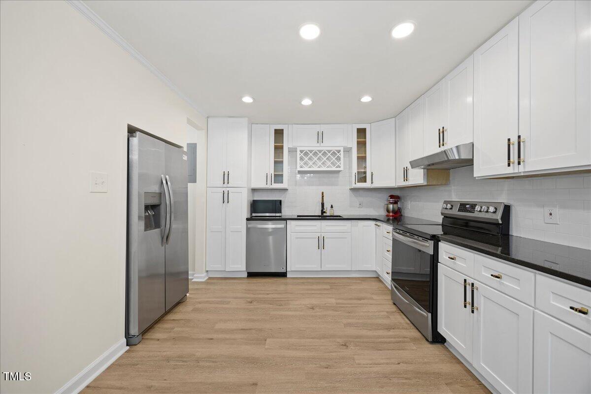 2013 Dartmouth Drive Durham, NC 27705 - Photo 12 of 32 a kitchen with stainless steel appliances granite countertop a refrigerator and a stove top oven