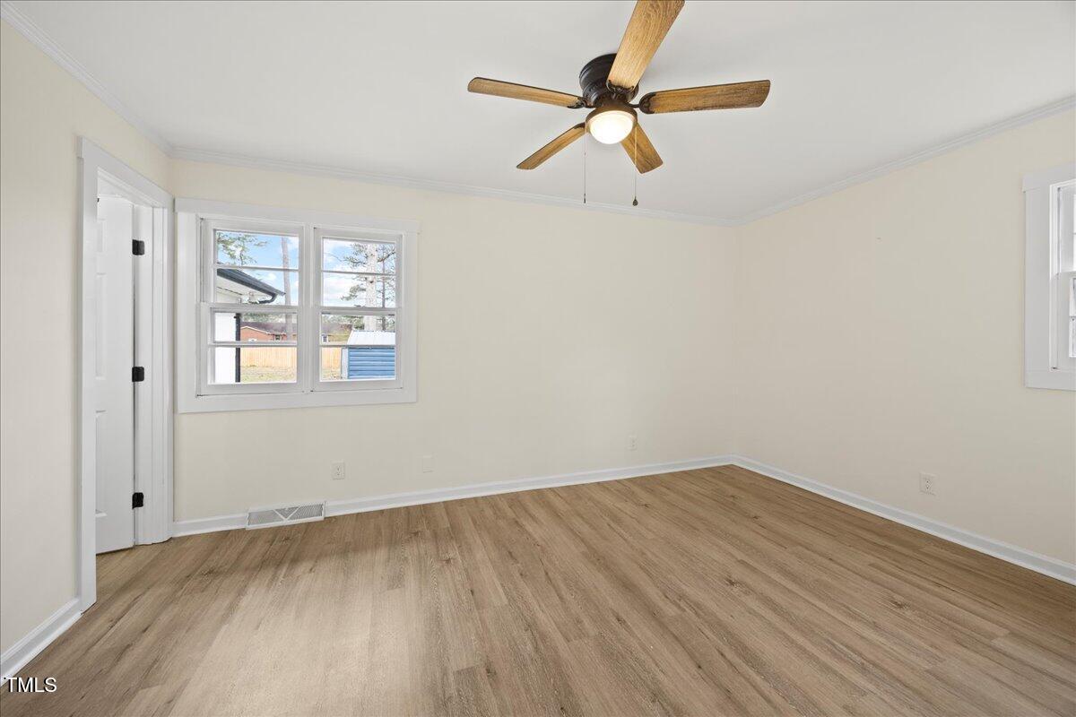 2013 Dartmouth Drive Durham, NC 27705 - Photo 16 of 32 an empty room with a window and a fan