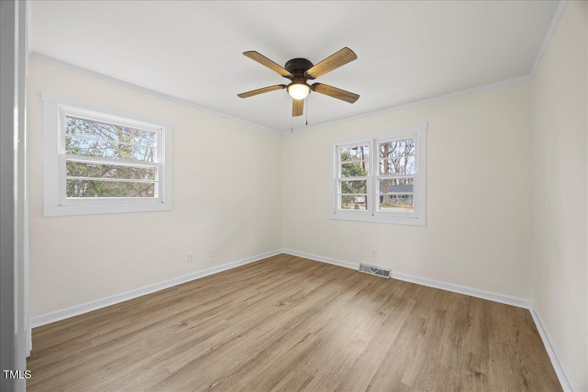 2013 Dartmouth Drive Durham, NC 27705 - Photo 18 of 32 a view of an empty room with wooden floor and a ceiling fan