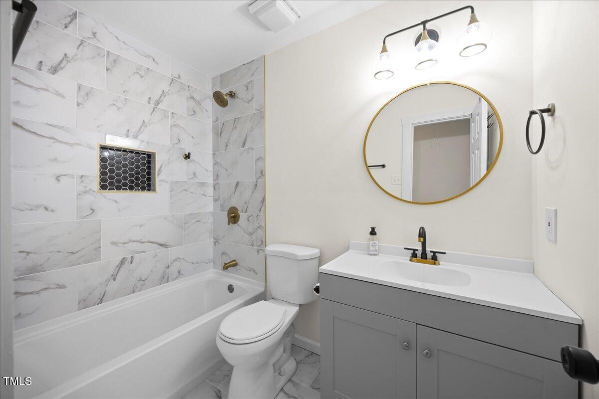 2013 Dartmouth Drive Durham, NC 27705 - Photo 22 of 32 a bathroom with a toilet sink and bathtub