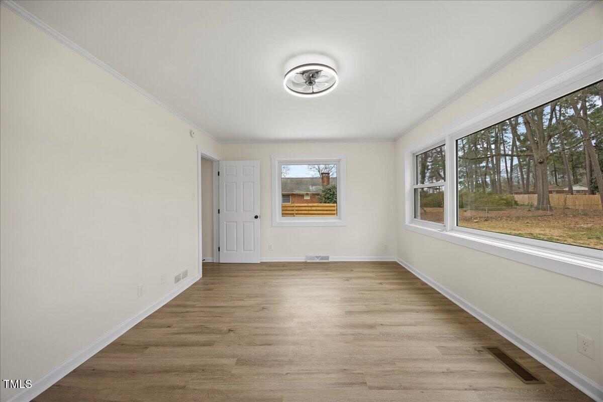 2013 Dartmouth Drive Durham, NC 27705 - Photo 24 of 32 an empty room with wooden floor and windows
