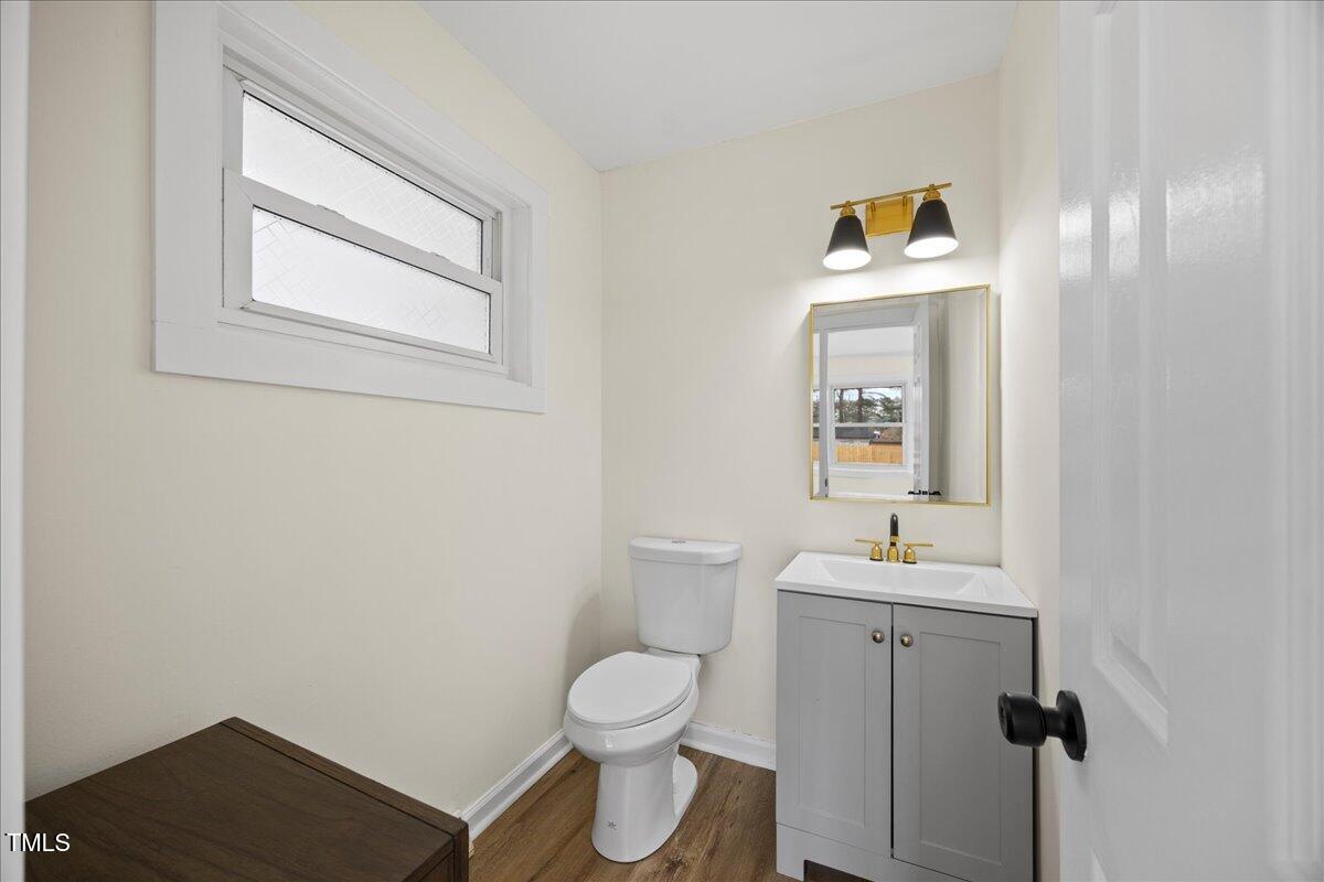 2013 Dartmouth Drive Durham, NC 27705 - Photo 25 of 32 a bathroom with a toilet a sink and mirror