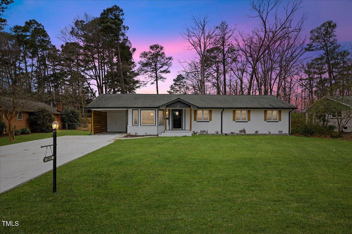 2013 Dartmouth Drive Durham, NC 27705 - Photo 2 of 32 a view of a house with a big yard and large tree