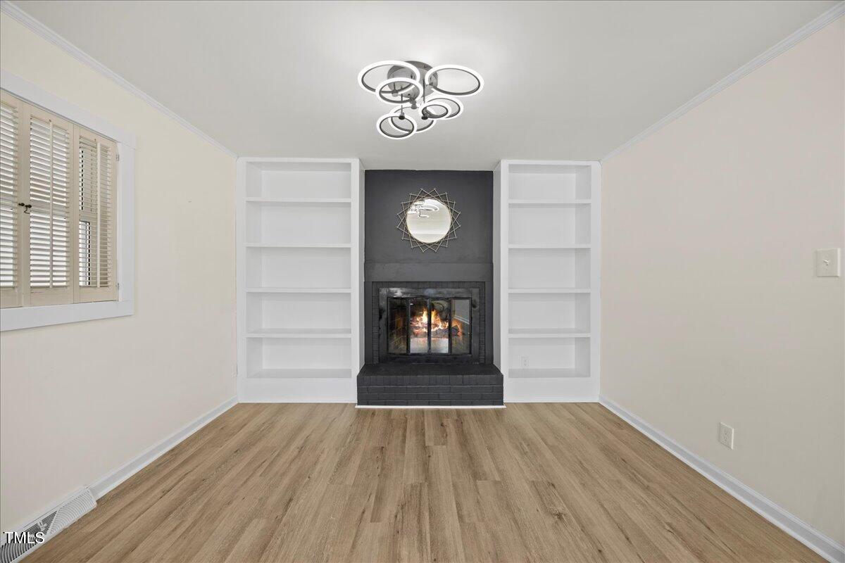 2013 Dartmouth Drive Durham, NC 27705 - Photo 7 of 32 a view of an empty room with wooden floor and a window