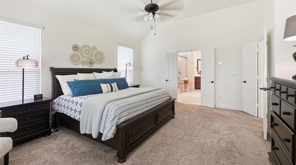 5216 Troupe Road McKinney, TX 75071 - Photo 20 of 40 Spacious bedroom featuring vaulted ceilings, plush carpeting, ceiling fan, and double doors to an adjoining room