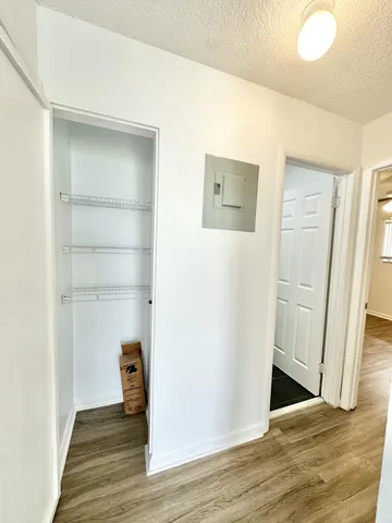 a view of a hallway with wooden floor