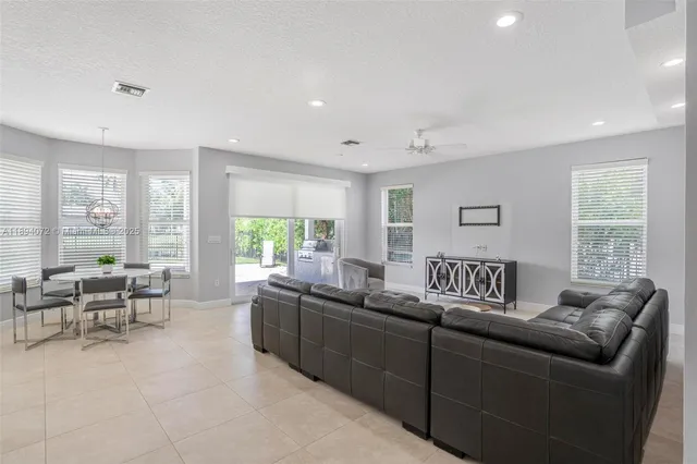 a living room with furniture and a large window