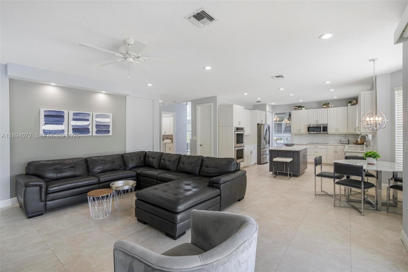 11750 Bayfield Drive Boca Raton, FL 33498 - Photo 14 of 52 a living room with furniture and kitchen view