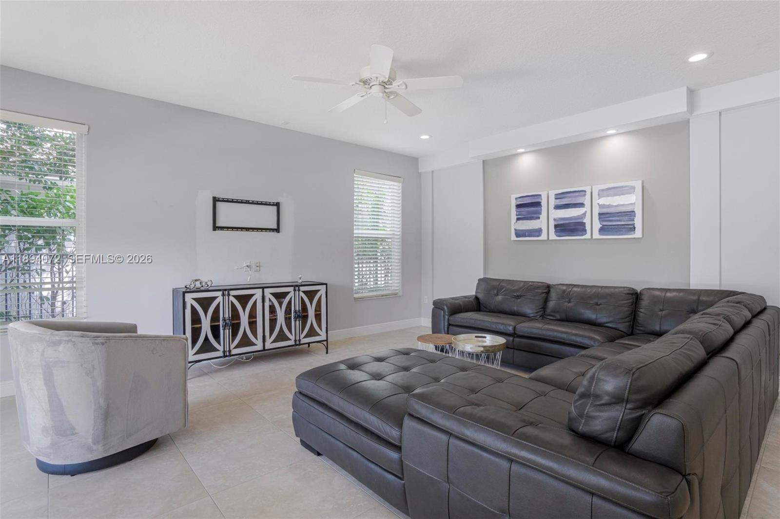 11750 Bayfield Drive Boca Raton, FL 33498 - Photo 15 of 52 a living room with furniture and a window