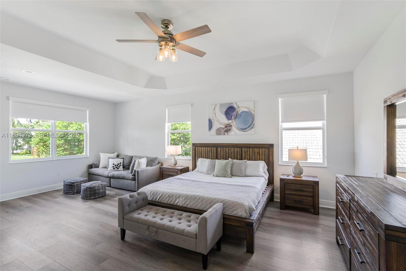 11750 Bayfield Drive Boca Raton, FL 33498 - Photo 27 of 52 a bedroom with a bed and a chandelier