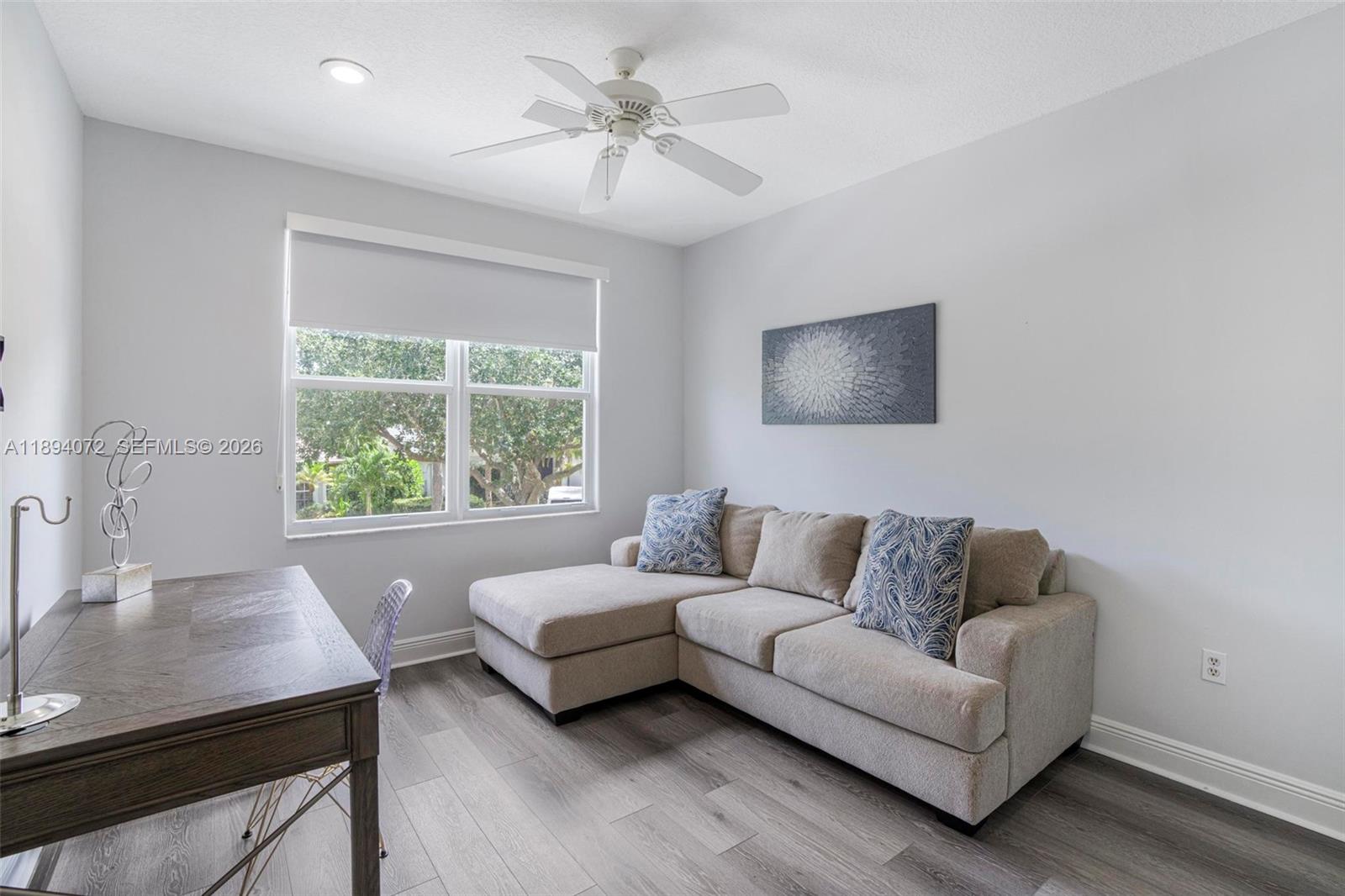 11750 Bayfield Drive Boca Raton, FL 33498 - Photo 32 of 52 a living room with furniture and a large window