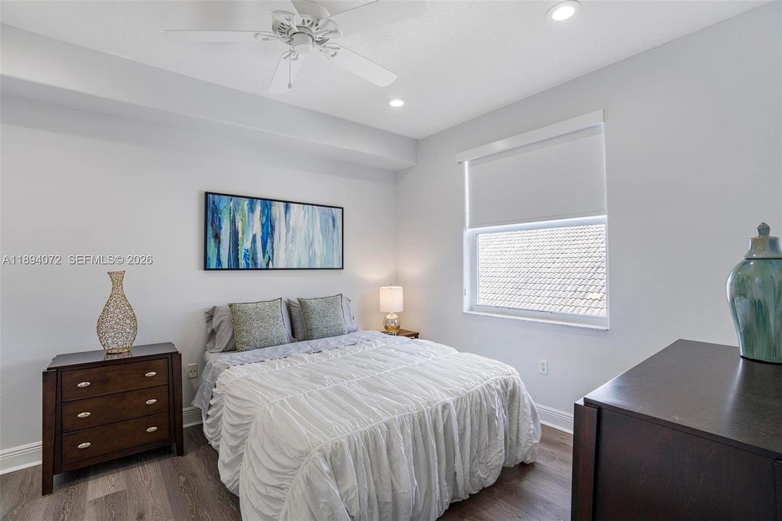 11750 Bayfield Drive Boca Raton, FL 33498 - Photo 33 of 52 a bedroom with a bed and a window