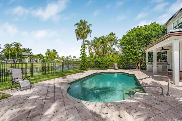 a front view of a house with a garden and yard