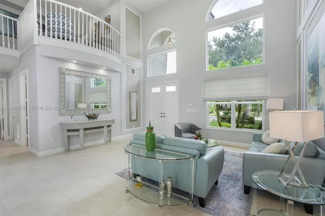 a living room with furniture and kitchen view