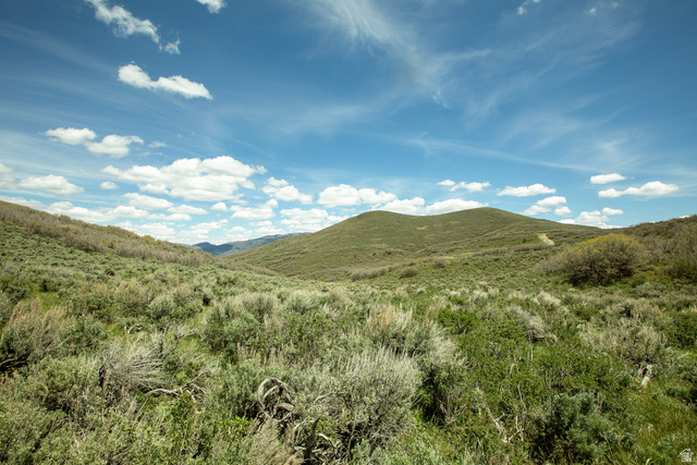 1646 North Miles Holw Road, Unit 29 Kamas, UT 84036 - Photo 32 of 35 Expansive natural landscape featuring rolling hills and varied green vegetation under a broad blue sky with scattered clouds