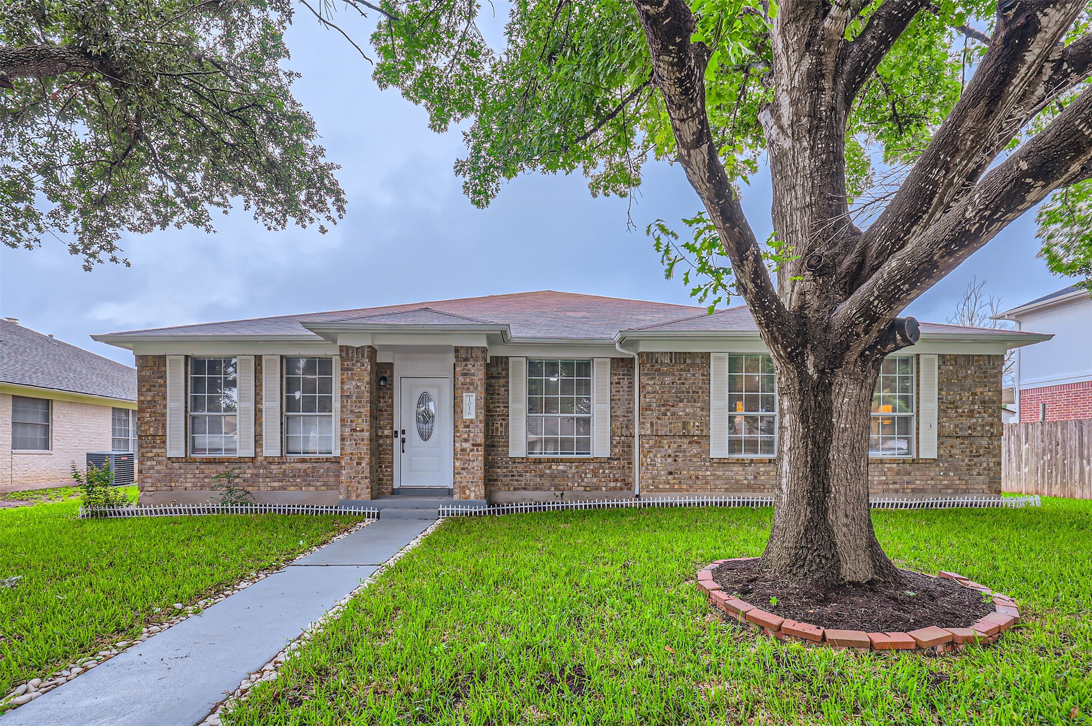 Ranch-style house with brick siding