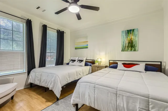 a bedroom with two beds and a chandelier